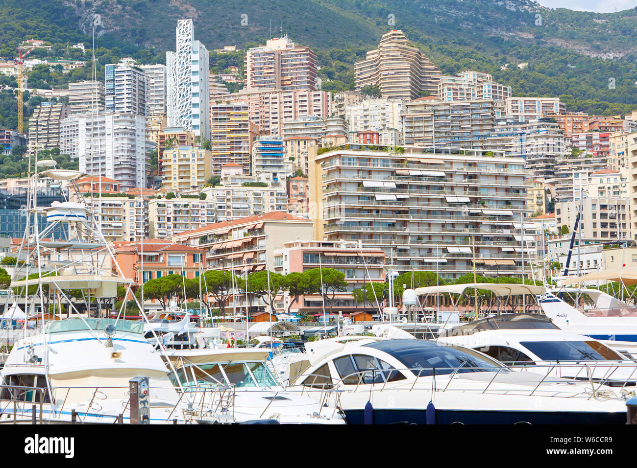 MONTE CARLO, MONACO - AUGUST 20, 2016: Monte Carlo harbor with boats, luxury yachts and city buildings in a summer day in Monte Carlo, Monaco. Stock Photo