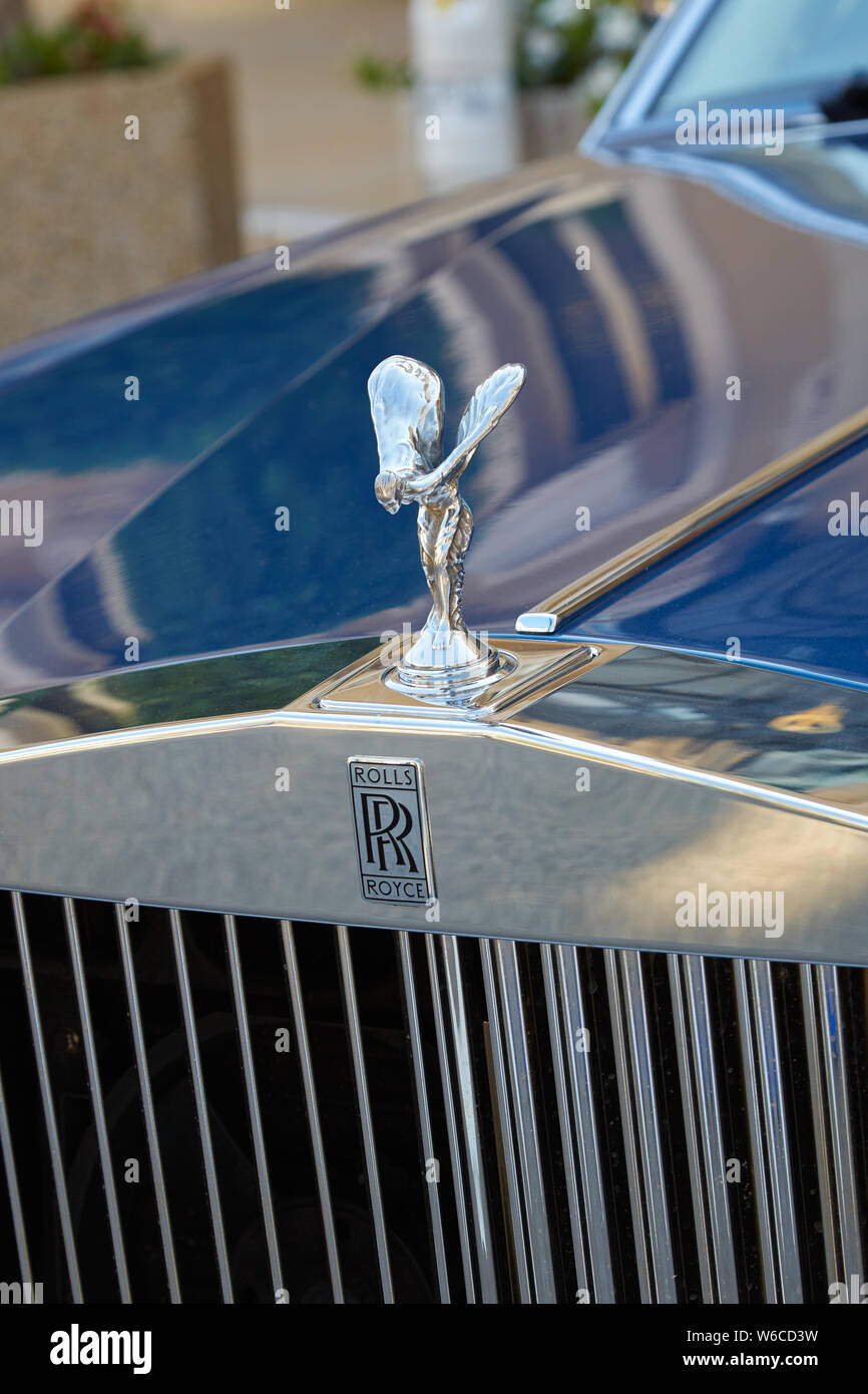 MONTE CARLO, MONACO - AUGUST 21, 2016: Rolls Royce luxury blue car, silver logo and statue detail in a summer day in Monte Carlo, Monaco. Stock Photo