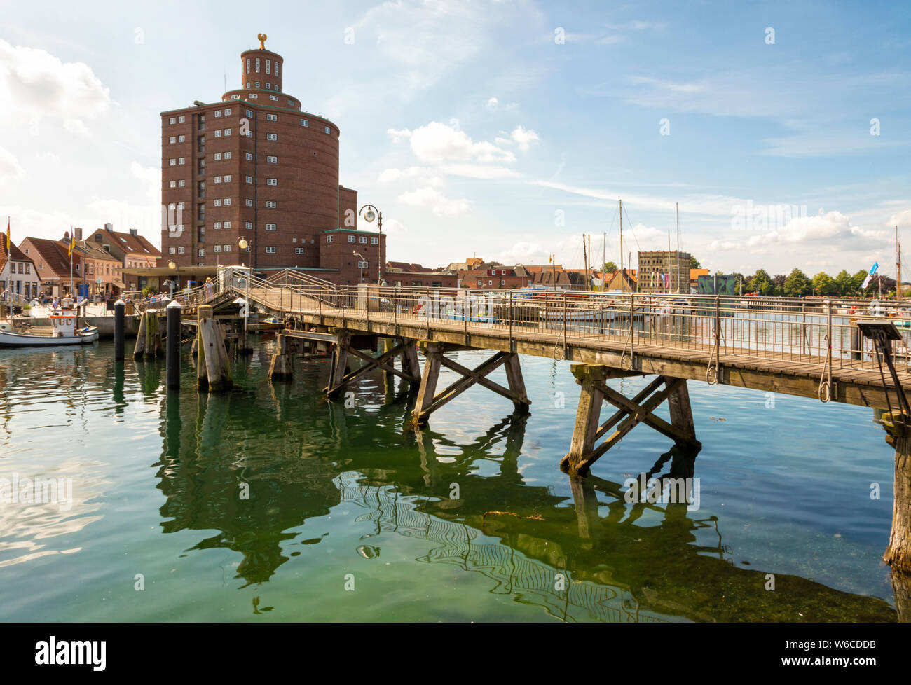 The historic warehouse known as Rundsilo and the wooden drawbridge at the harbor of Eckernförde on the Baltic Sea coast Stock Photo