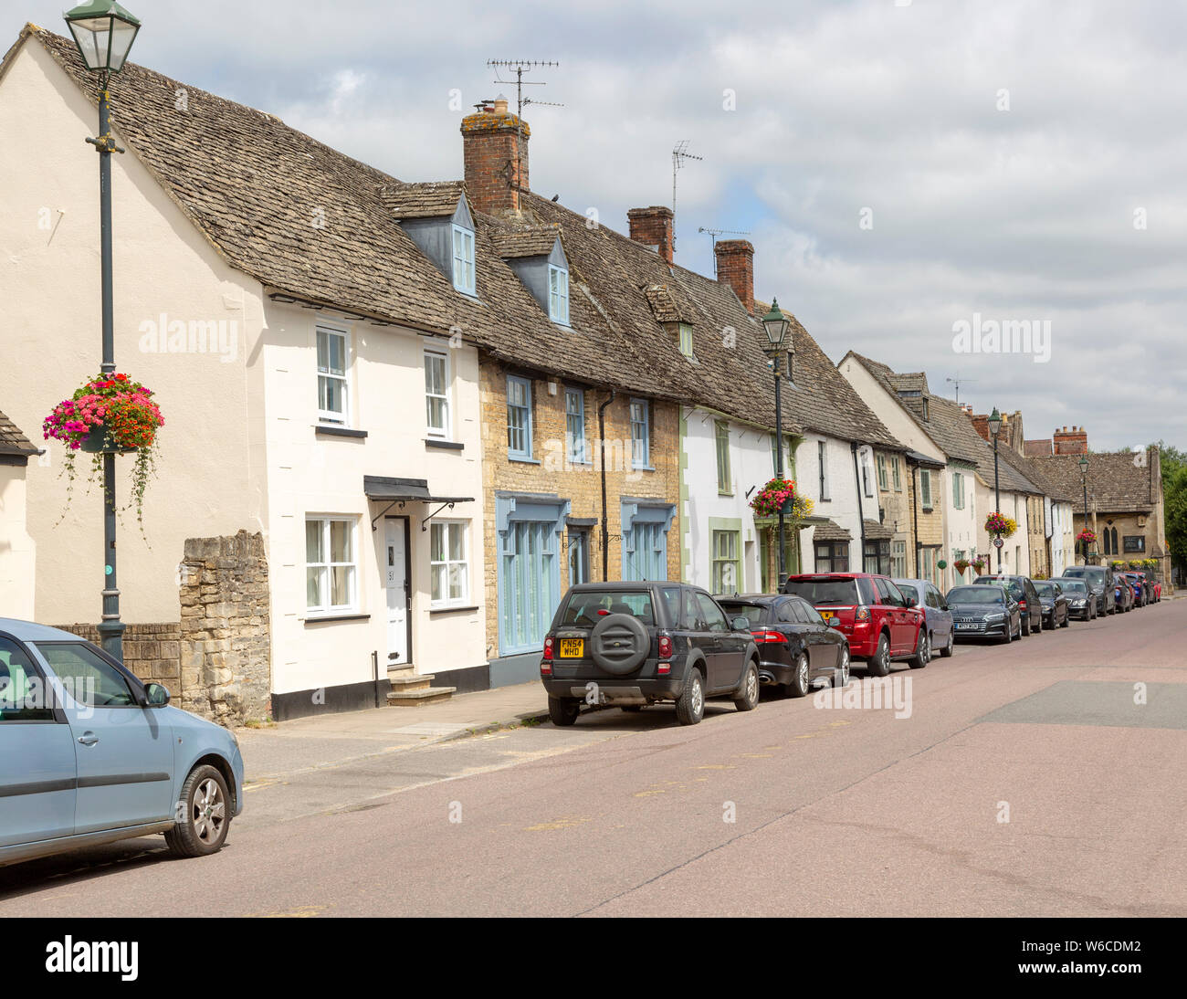 Cars parked on street frontage outside historic building in Saxon town