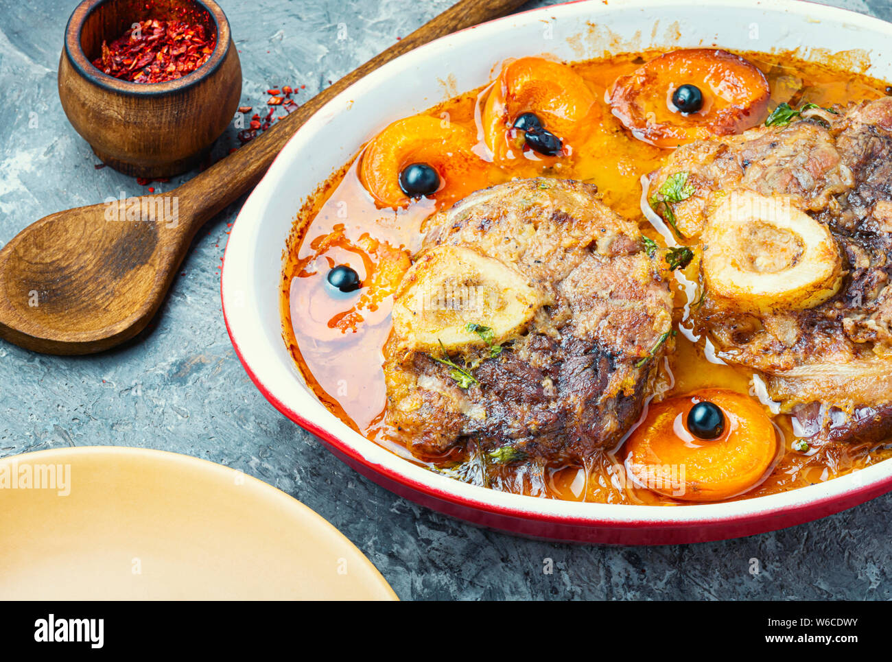 Ossobuco, traditional dish of Italian cuisine. Stewed veal leg.Italian food Stock Photo