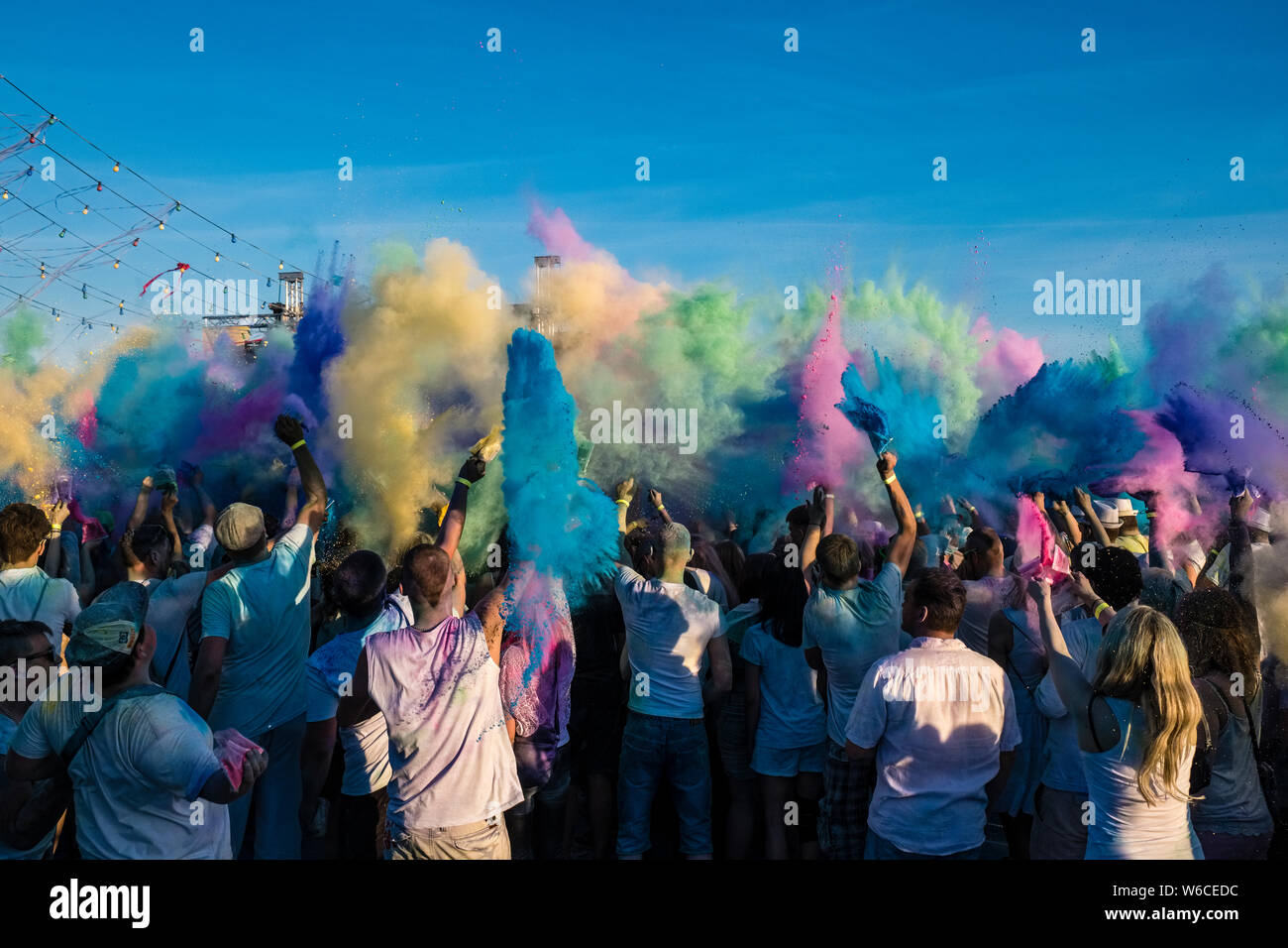 https://c8.alamy.com/comp/W6CEDC/hundreds-of-young-people-are-celebrating-holi-the-festival-of-colors-throwing-color-powder-in-the-air-W6CEDC.jpg