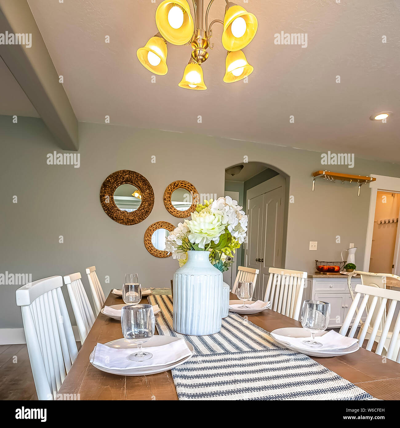 Square frame Dining room interior of a home with brown wooden table and
