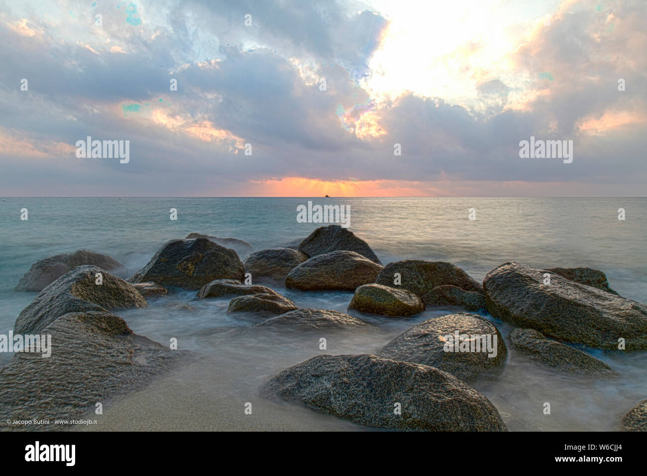 Landscape: Italy, on the beach at sunset rocks on the sea Stock Photo