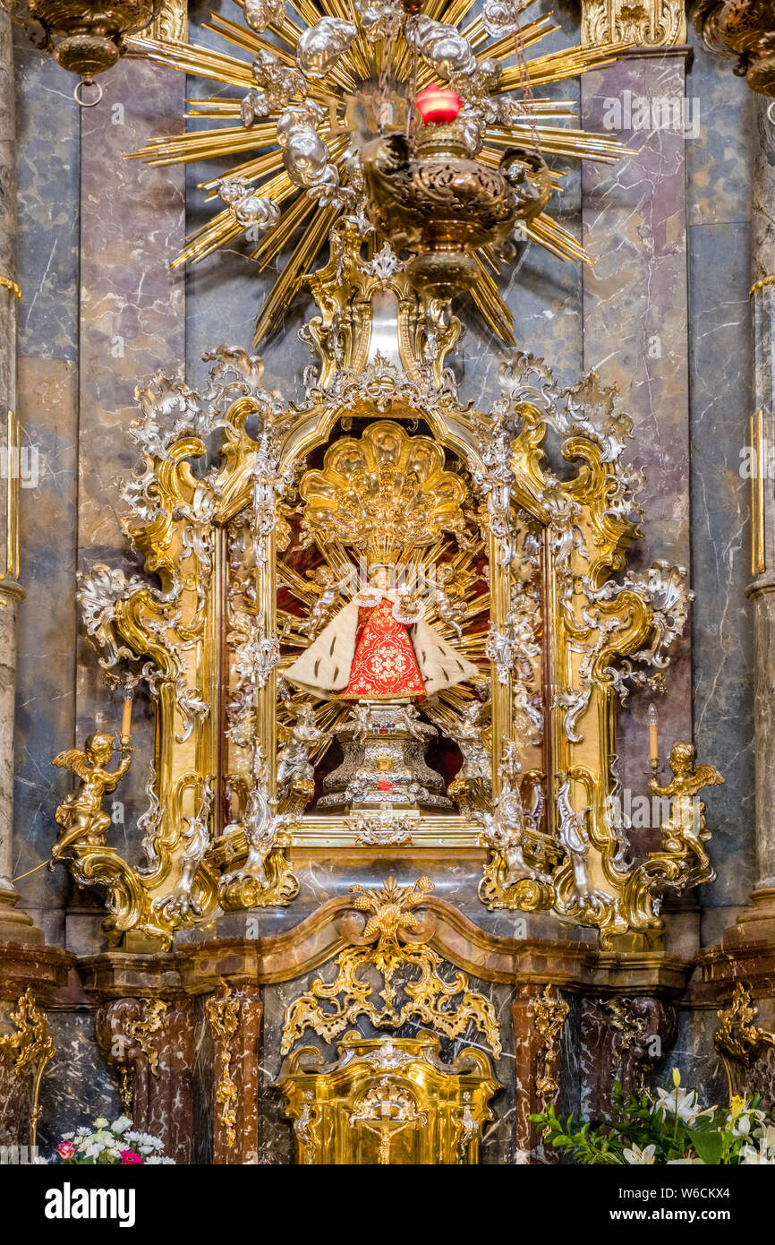 The golden altar with the statue of the Infant Jesus of Prague inside the Church of Our Lady Victorious Stock Photo