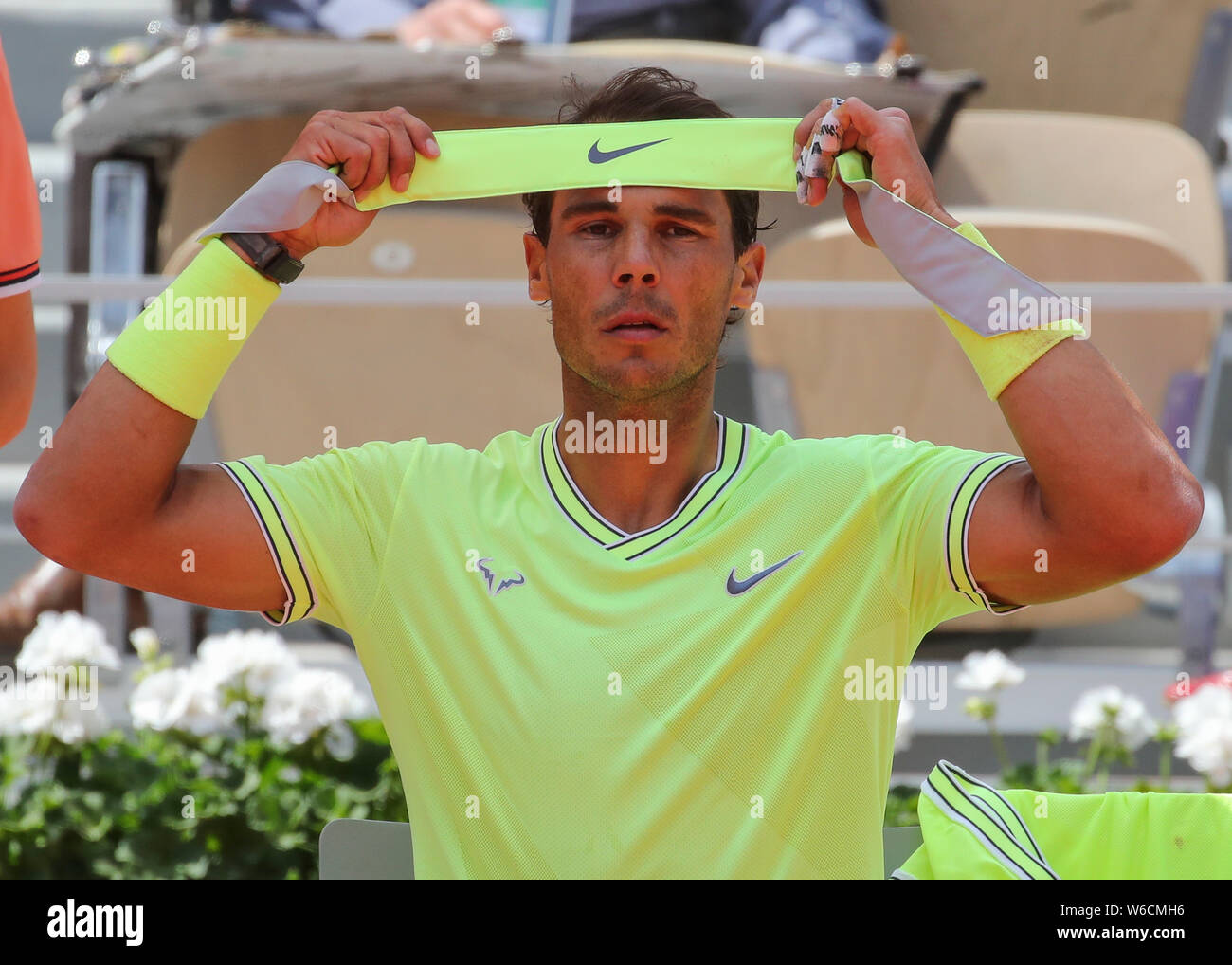 Portrait of Spanish tennis player Rafael Nadal tying headband