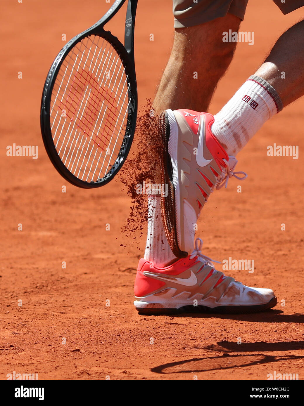 Swiss tennis player Roger Federer cleaning soil from his shoe with racquet  during French Open 2019, Paris, France Stock Photo - Alamy
