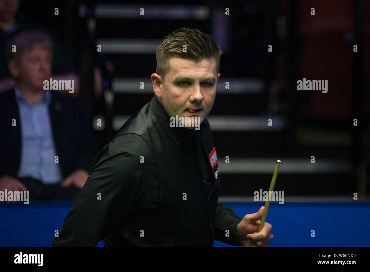 Ryan Day of Wales considers a shot to Anthony McGill of Scotland in their first round match during the 2018 Betfred World Snooker Championship at the Stock Photo