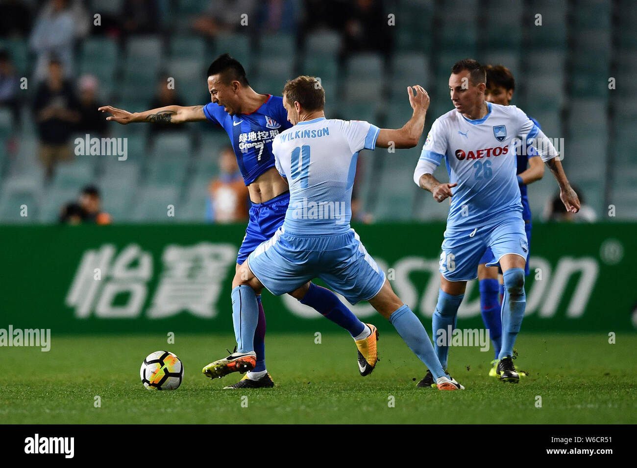Alex Wilkinson, center, of Australia's Sydney FC challenges Mao Jianqing of China's Shanghai Shenhua FC in their Group H match during the 2018 AFC Cha Stock Photo