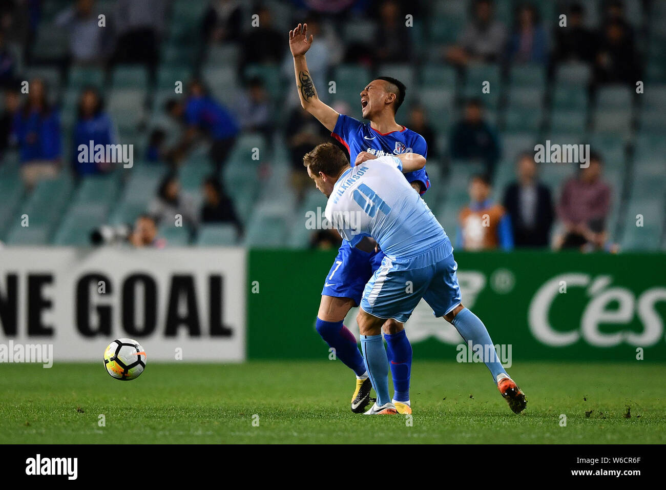 Alex Wilkinson, front, of Australia's Sydney FC challenges Mao Jianqing of China's Shanghai Shenhua FC in their Group H match during the 2018 AFC Cham Stock Photo