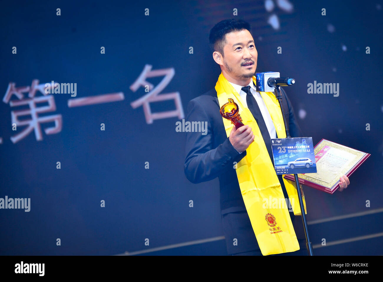 Chinese actor and director Wu Jing or Jacky Wu poses with his trophy