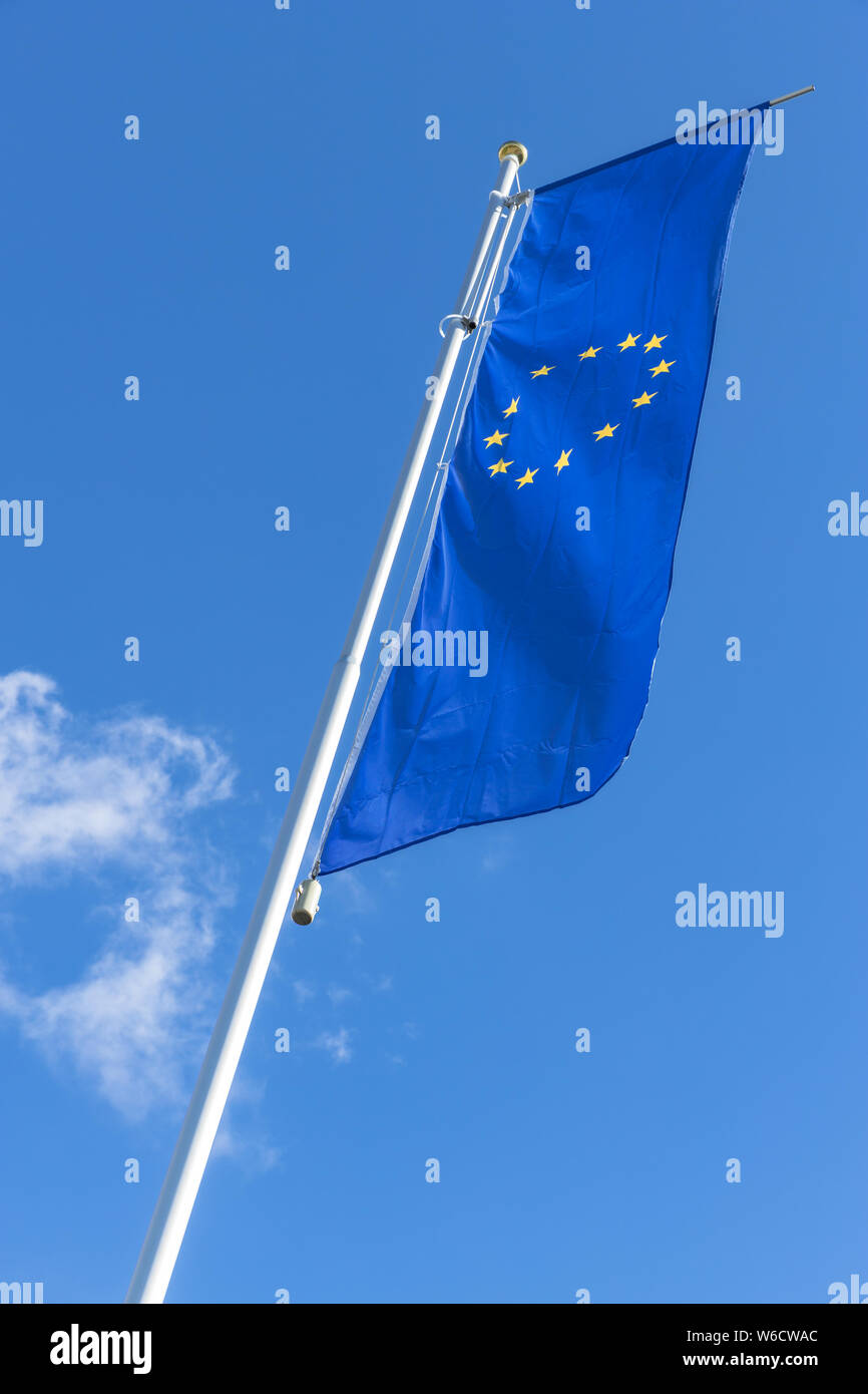 Flag of the European Union waving in the wind on flagpole against the ...