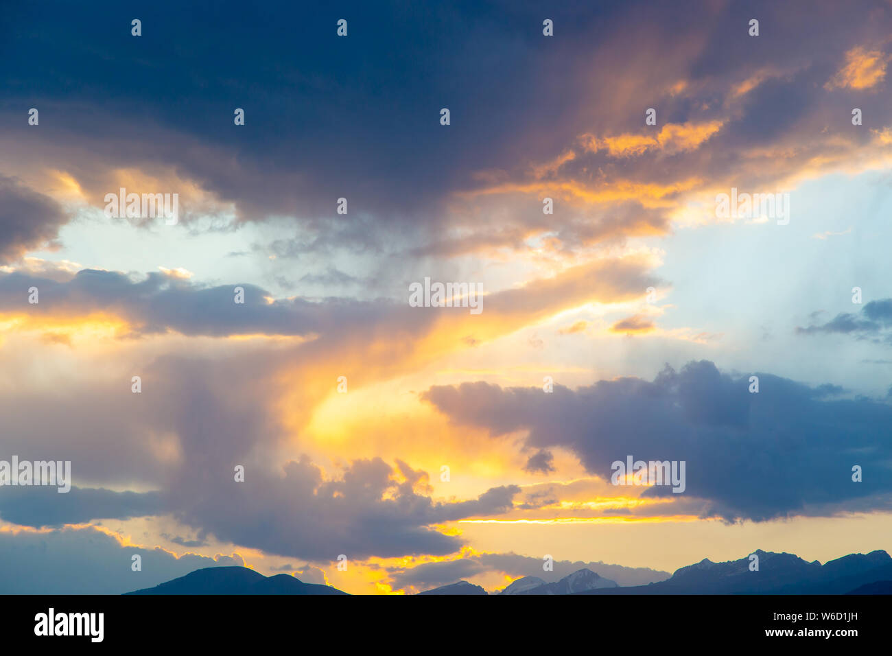 soft sunset sky. pink and gold clouds. High mountains Stock Photo Alamy