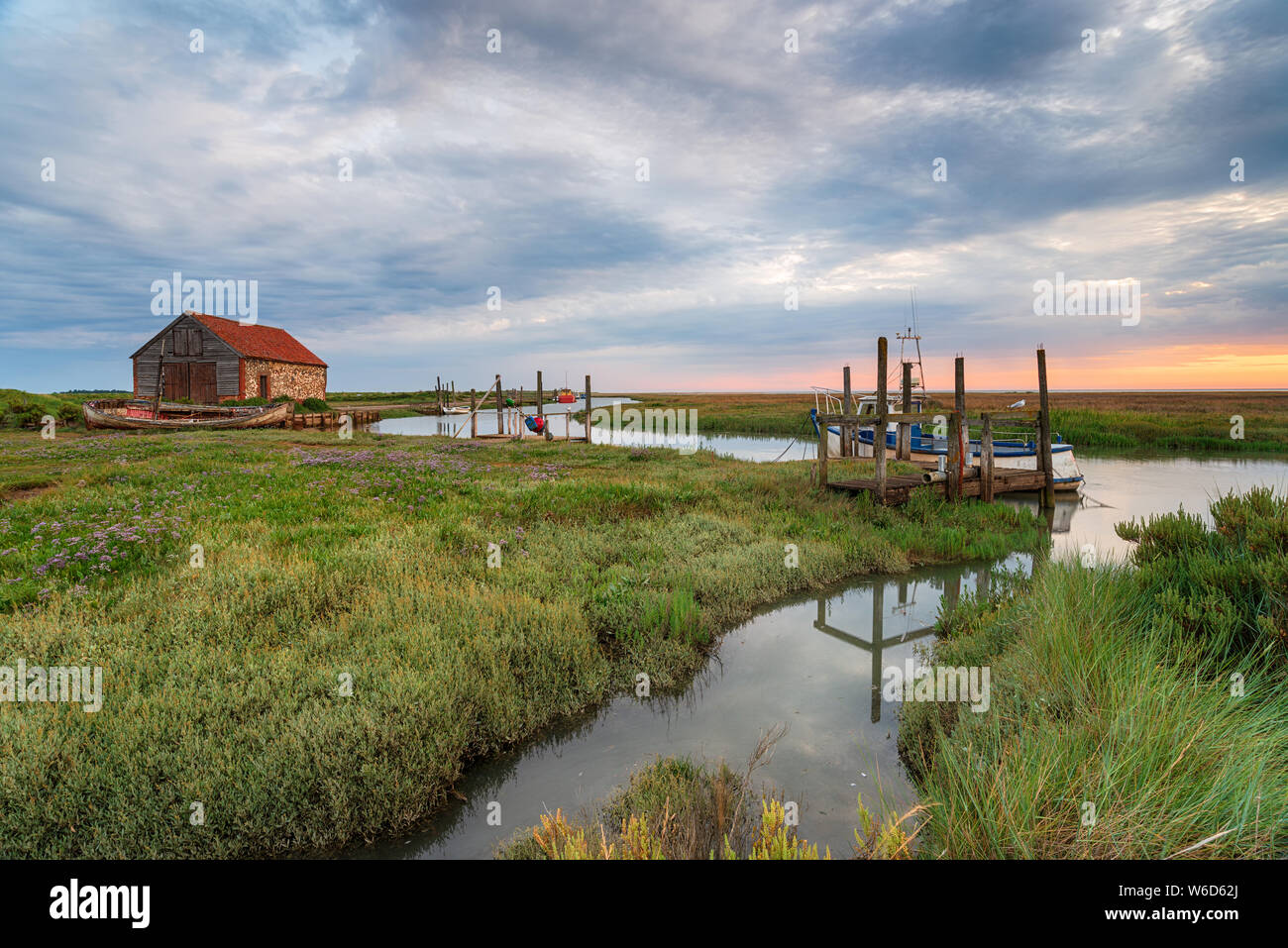 Moody sunrise at the old harbour at Thornham near Hunstanton on the north coast of Norfolk Stock Photo