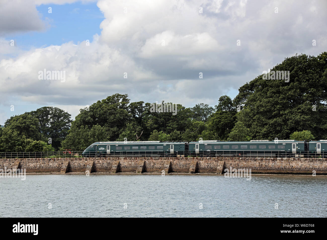 Great Western Railway train on the famous coastal route from Exeter to Newton Abbot beside the River Exe and English Channel  in south Devon Stock Photo