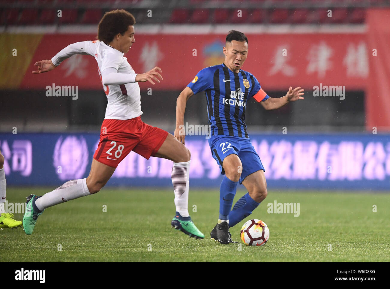 Belgian football player Axel Witsel of Tianjin Quanjian, left, challenges Wu Xi of Jiangsu Suning in their sixth round match during the 2018 Chinese F Stock Photo