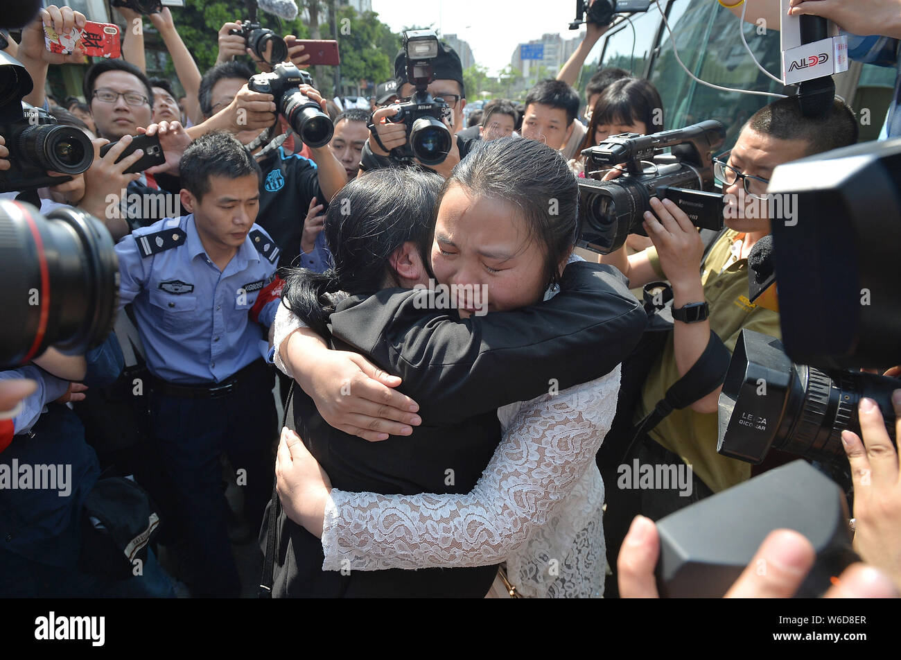 The wife of Chinese ride-sharing driver Wang Mingqing weeps as she ...