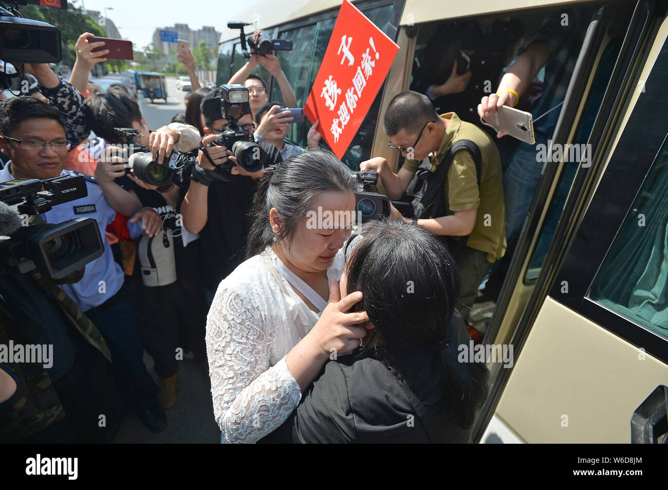 The wife of Chinese ride-sharing driver Wang Mingqing weeps as she ...