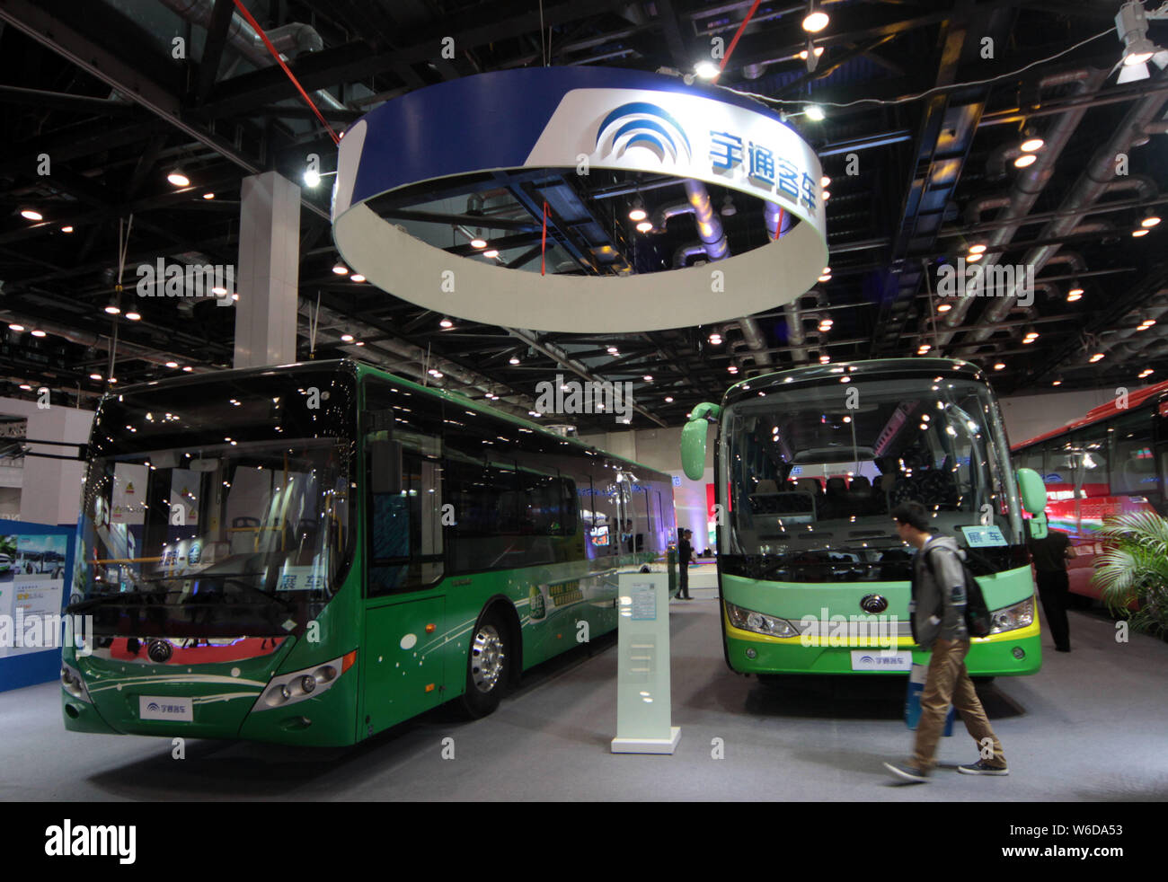 --FILE--People visit the stand of Zhengzhou Yutong Bus Co. during an exhibition in Beijing, China, 14 May 2014.   The German intercity bus service com Stock Photo
