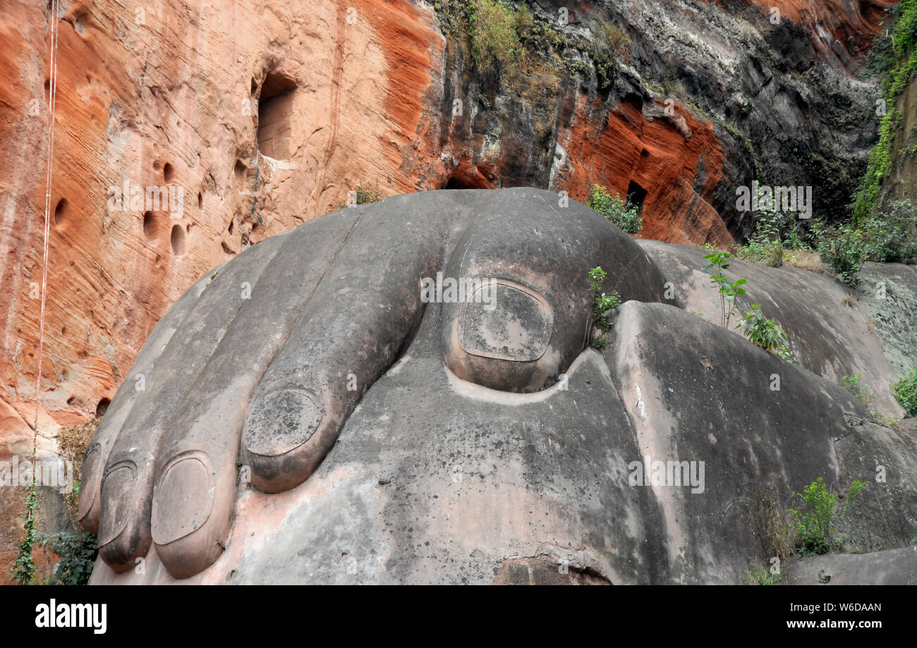 The Leshan Giant Buddha or Leshan Grand Buddha near Chengdu. This is the tallest stone Buddha statue in the world. Leshan Buddha, Sichuan, hand, knee. Stock Photo