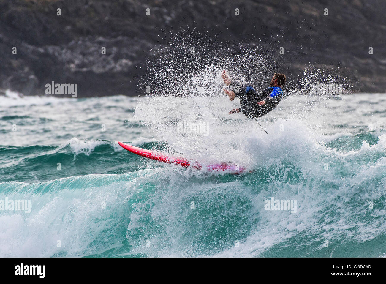 A surfer wipe wiping out at Fistral in Newquay in Cornwall. Stock Photo