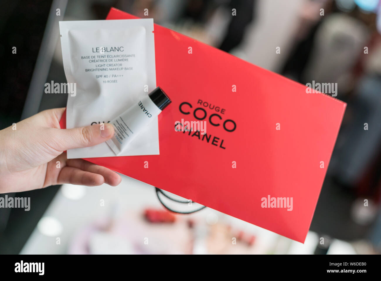 A visitor shows makeup samples at the Coco Game Center of Chanel