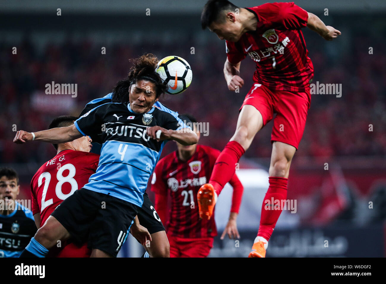 Yoshito Okubo Left Of Japan S Kawasaki Frontale Heads The Ball To Make A Pass Against Players Of China S Shanghai Sipg Fc In A Group F Match During Stock Photo Alamy