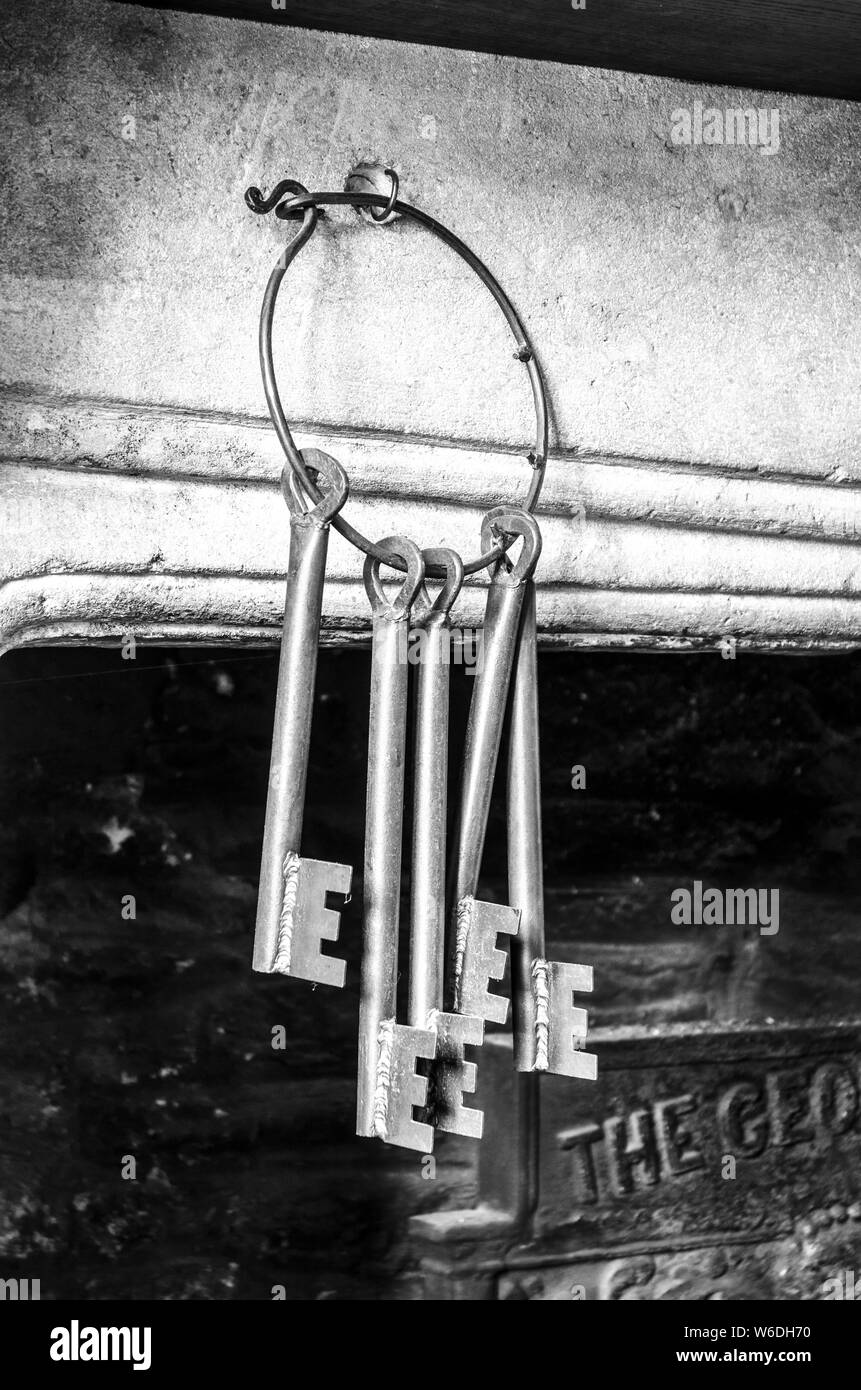 Old Wrought Iron Keys Hanging On A Fireplace Stock Photo