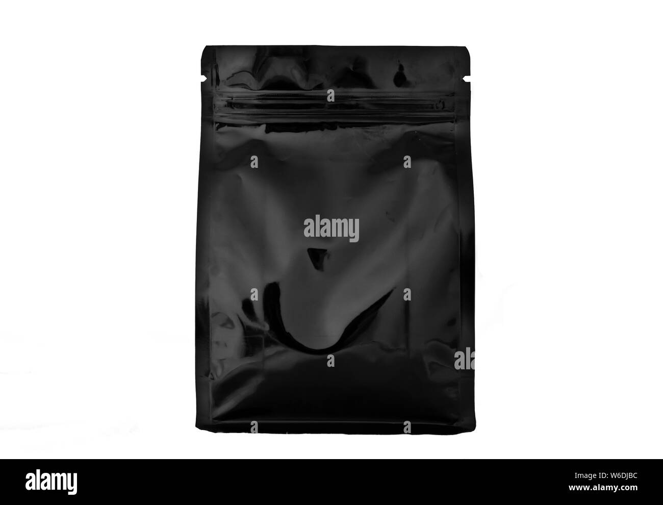 matt black plastic and aluminium flat bottom coffee pouch  with zipper  filled with coffee beans on white background fron view Stock Photo