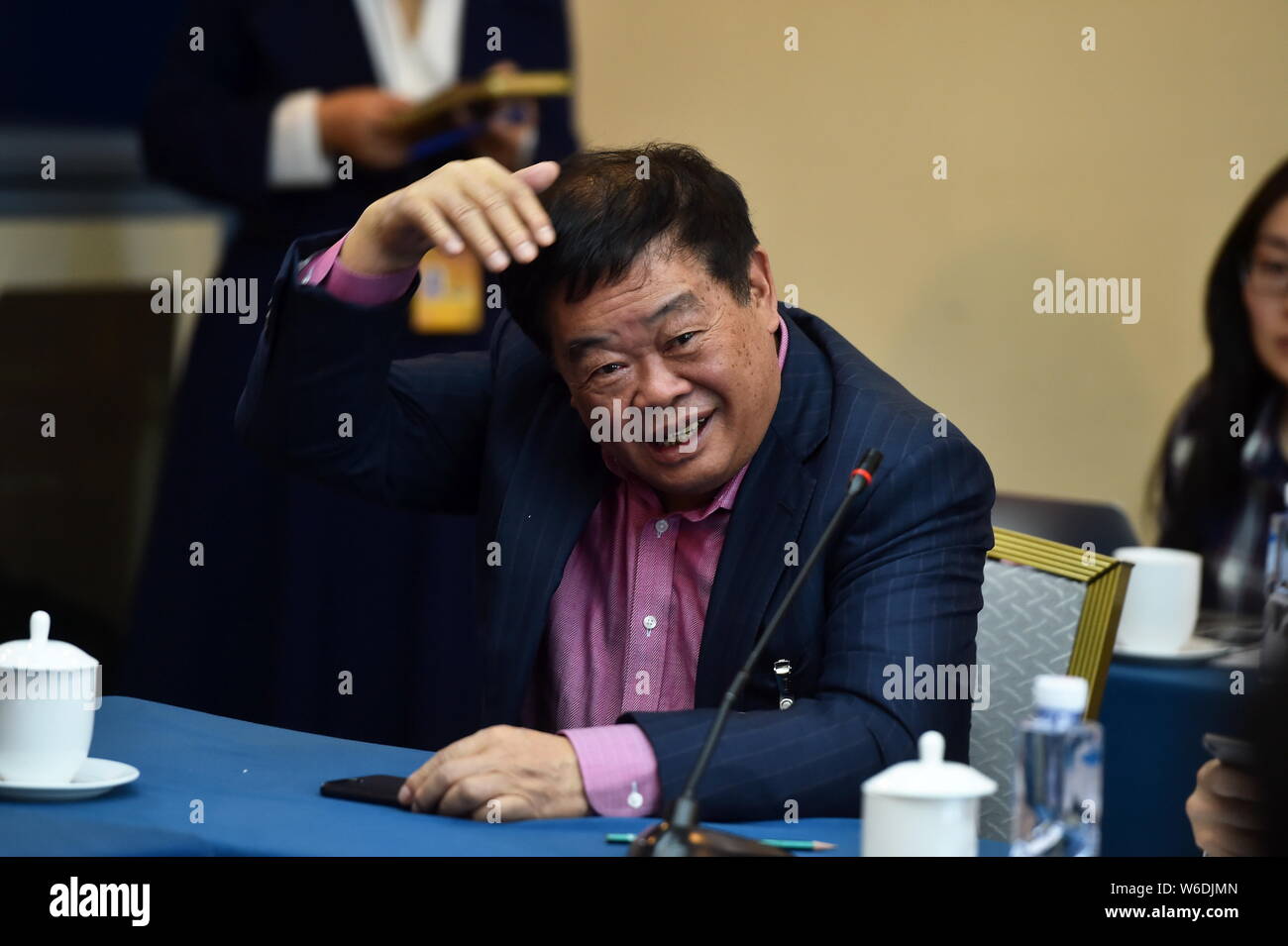 --FILE--Cho Tak Wong (Cao Dewang), Chairman of Fuyao Group and Chairman of Fuyao Glass Industry Group Co., attends a panel discussion during the Fifth Stock Photo