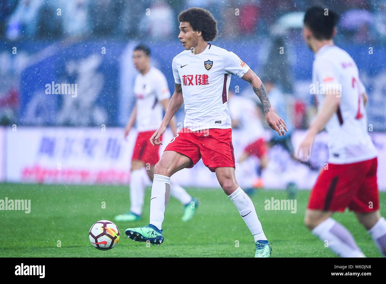 Belgian football player Axel Witsel of Tianjin Quanjian kicks the ball to make a pass against Dalian Yifang in their seventh round match during the 20 Stock Photo
