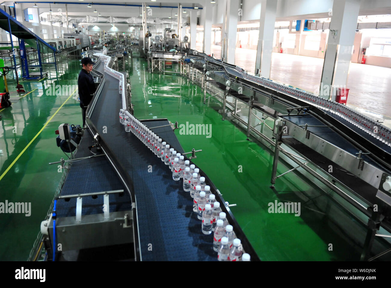 --FILE--A Chinese worker checks bottles of Wahaha purified water on the ...