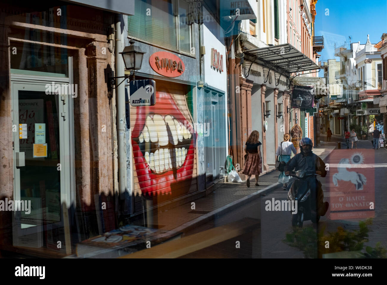 Street scene on the main commercial street of the town of Mytilene on the Greek island of Lesvos during the late afternoon. Stock Photo