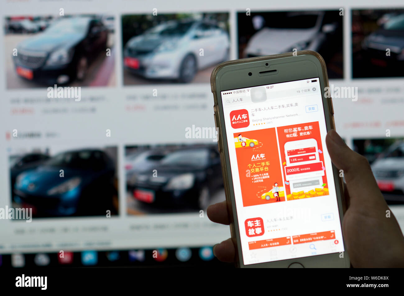 --FILE--A Chinese mobilephone user use the App of Chinese second-hand car trading platform Renrenche on his smartphone in Guangzhou city, south China' Stock Photo