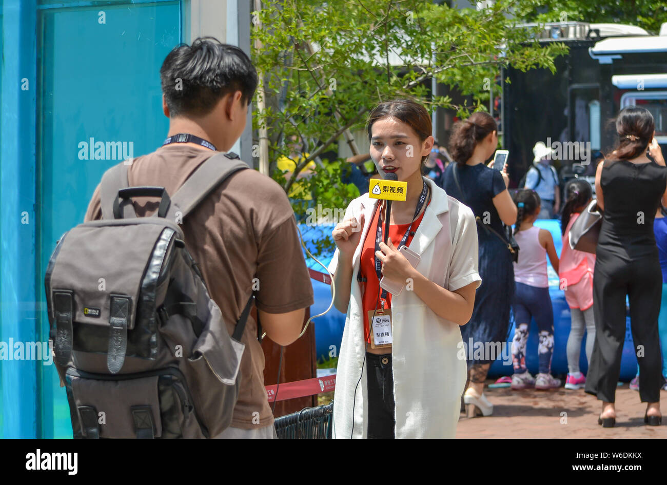 --FILE--A reporter of short video platform Pear Video interviews during the first Mermaid Festival at the 2017 Asia Dive Expo (ADEX) in Shenzhen city, Stock Photo