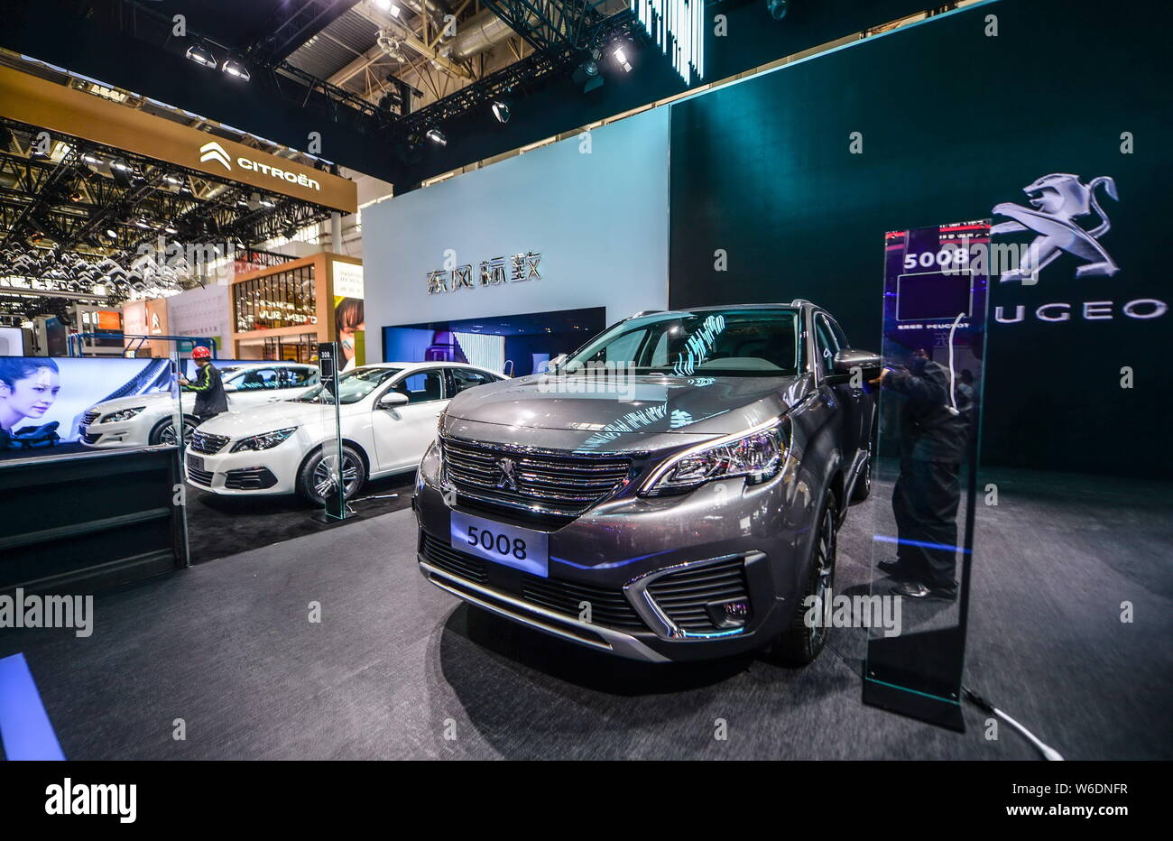 A Peugeot 5008 SUV and other Peugeot cars are on display during a preview of the 15th Beijing International Automotive Exhibition, also known as Auto Stock Photo
