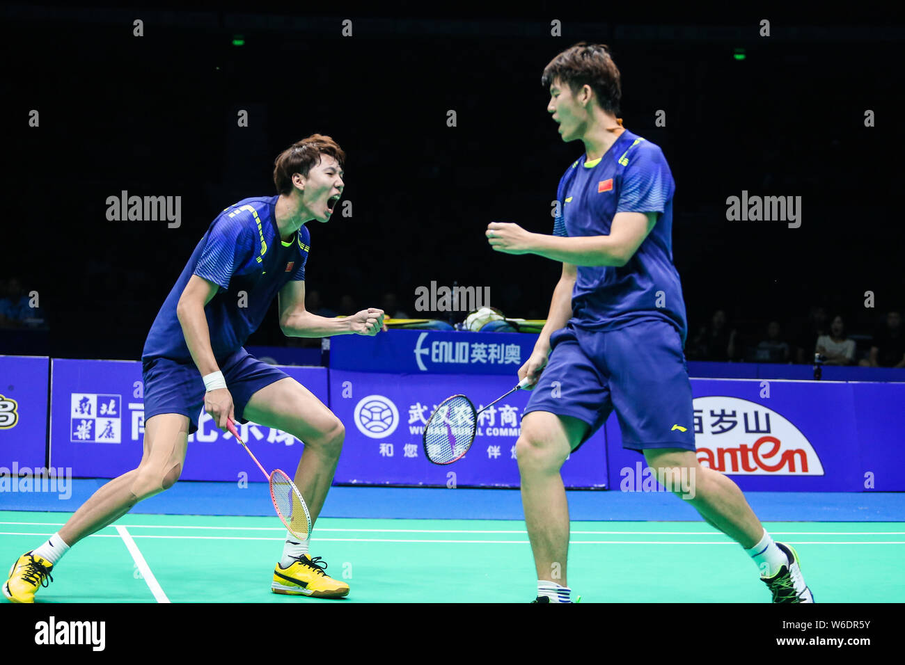 Li Junhui, left, and Liu Yuchen of China interact after scoring against ...