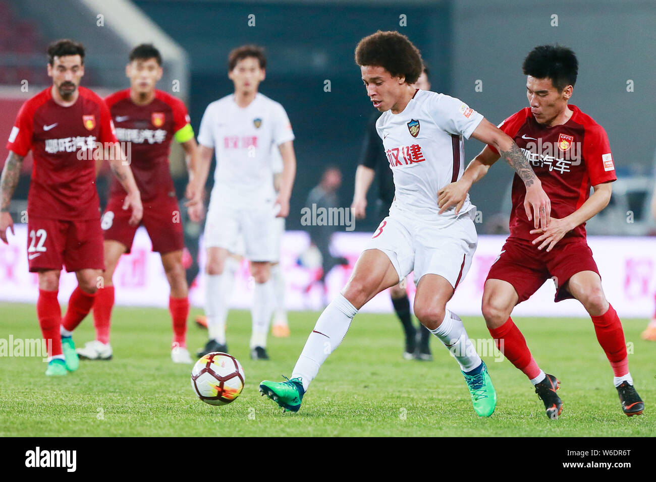 Belgian football player Axel Witsel of Tianjin Quanjian, left, challenges a player of Hebei China Fortune in their 8th round match during the 2018 Chi Stock Photo