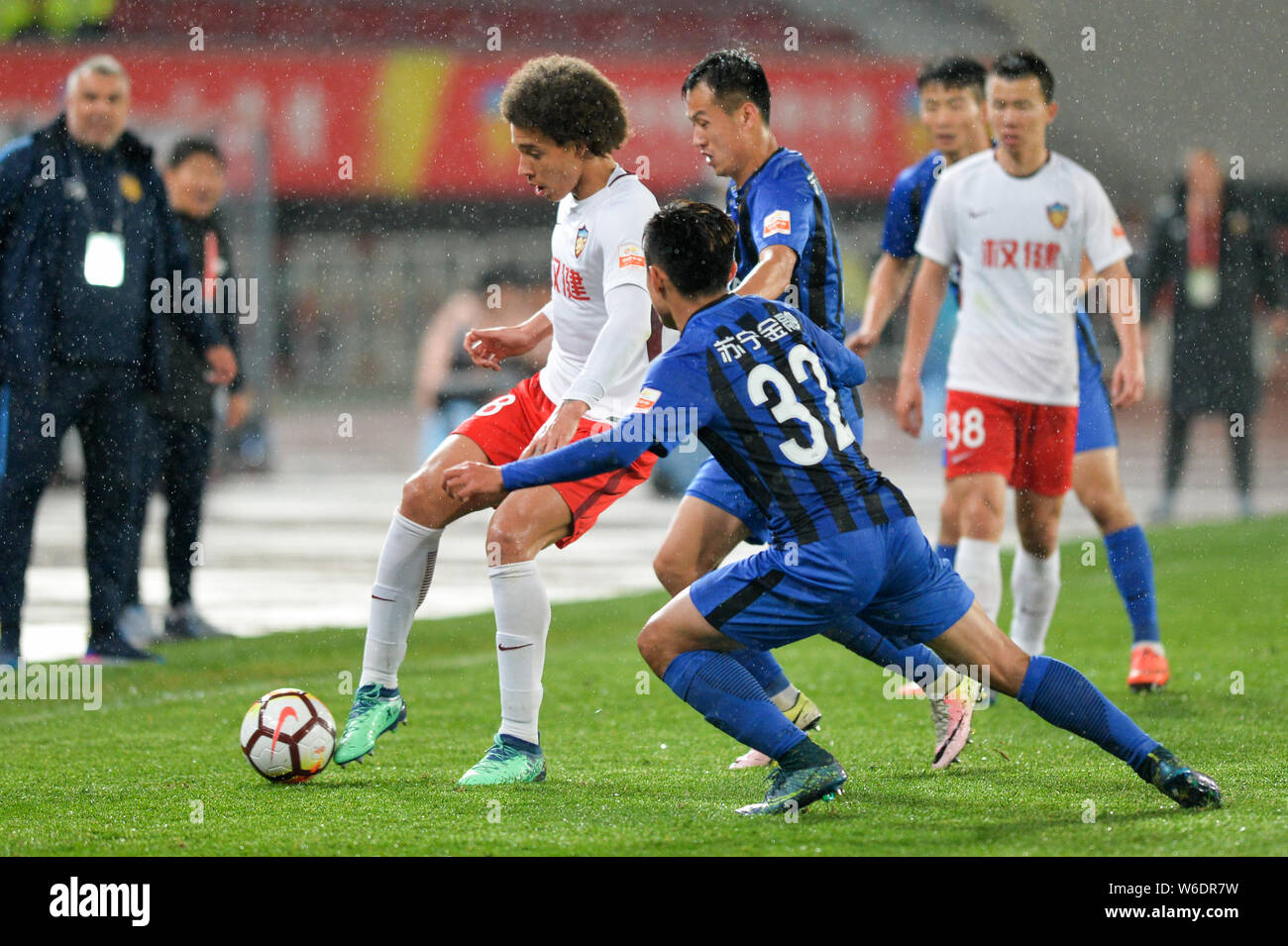 Belgian football player Axel Witsel of Tianjin Quanjian, left, challenges Huang Zichang of Jiangsu Suning in their sixth round match during the 2018 C Stock Photo