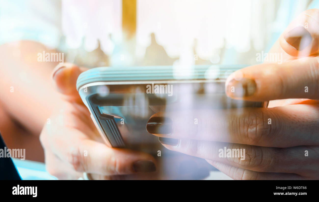Hands with mobile, double exposure Stock Photo