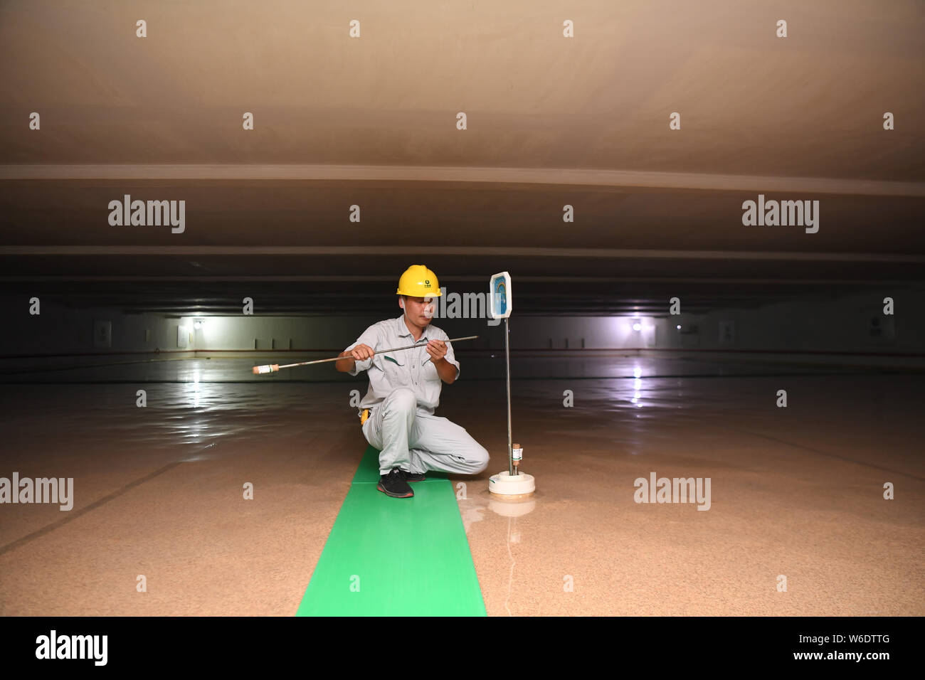 Changsha, China's Hunan Province. 30th July, 2019. A worker from Ningxiang subordinated storehouse of China's state grain stockpiler Sinograin checks the temperature of the grain in Ningxiang, central China's Hunan Province, July 30, 2019. The sampling inspection is applied to ensure the quality of the grain being stored, followed by a series of advanced technologies used to keep the grain from deterioration. Credit: Xue Yuge/Xinhua/Alamy Live News Stock Photo