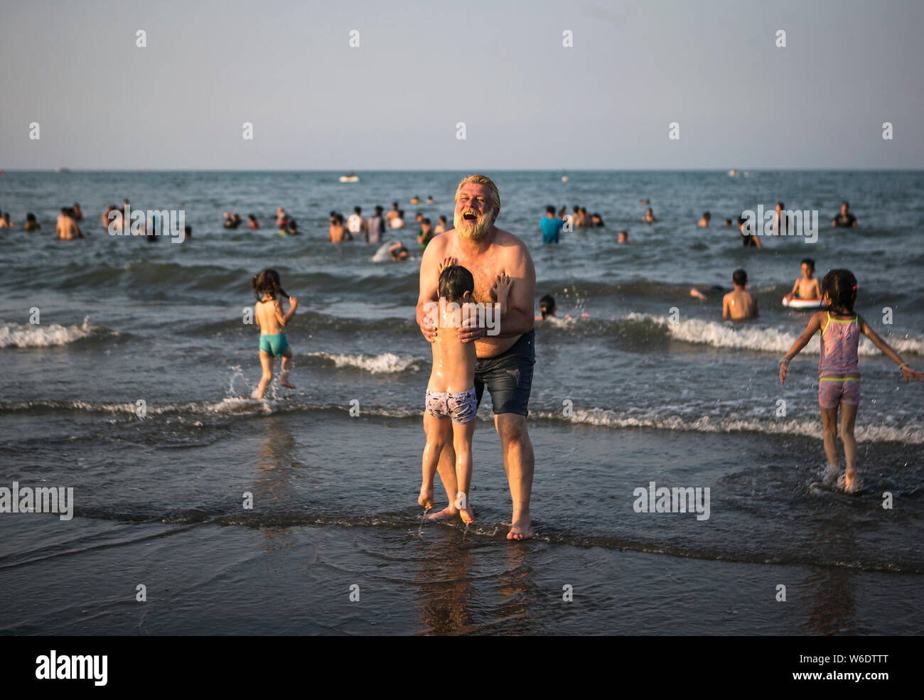 190801) -- RAMSAR, Aug. 1, 2019 (Xinhua) -- Locals enjoy their leisure time  at the Caspian sea beach in Ramsar city, northern Iran, on July 31, 2019.  (Photo by Ahmad Halabisaz/Xinhua Stock Photo - Alamy