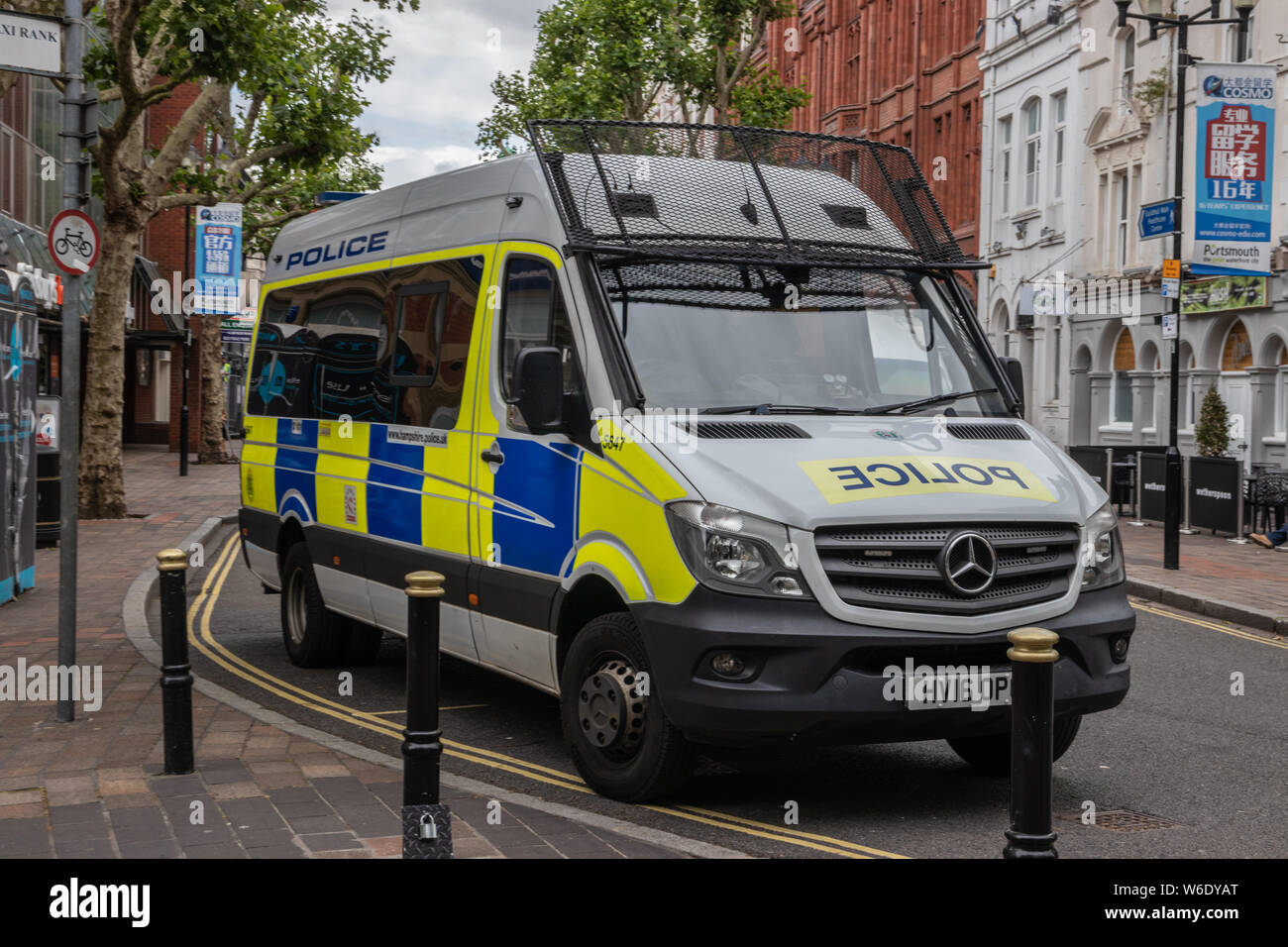 A British police van or meat wagon with windshield protectors in an English road Stock Photo
