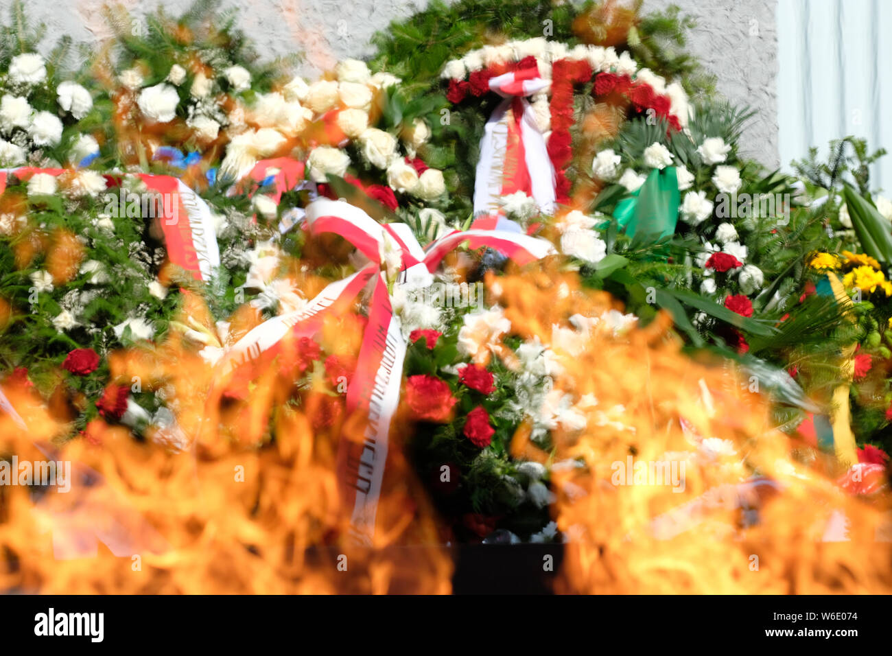 Warsaw Poland - Thursday 1st August - Wreathes and flowers laid behind the memorial flames of the Warsaw Uprising monument in Warsaw as Poland commemorates the 75th Anniversary of the Warsaw Uprising ( Powstanie Warszawskie ) against the occupying German Army on 1st August 1944 - the Warsaw Uprising resistance fighters of the Home Army ( Armia Krajowa  - AK ) struggled on for 63 days against the Nazi forces before capitulation as the advancing Soviet Army waited across the nearby River Vistula. Photo Steven May / Alamy Live News Stock Photo