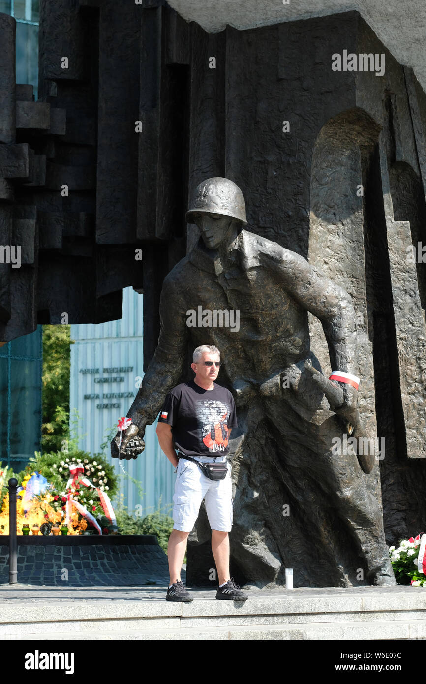 Warsaw Poland - Thursday 1st August - A Polish man stands proudly in front of the Warsaw Uprising monument in Warsaw as Poland commemorates the 75th Anniversary of the Warsaw Uprising ( Powstanie Warszawskie ) against the occupying German Army on 1st August 1944 - the Warsaw Uprising resistance fighters of the Home Army ( Armia Krajowa  - AK ) struggled on for 63 days against the Nazi forces before capitulation as the advancing Soviet Army waited across the nearby River Vistula. Photo Steven May / Alamy Live News Stock Photo