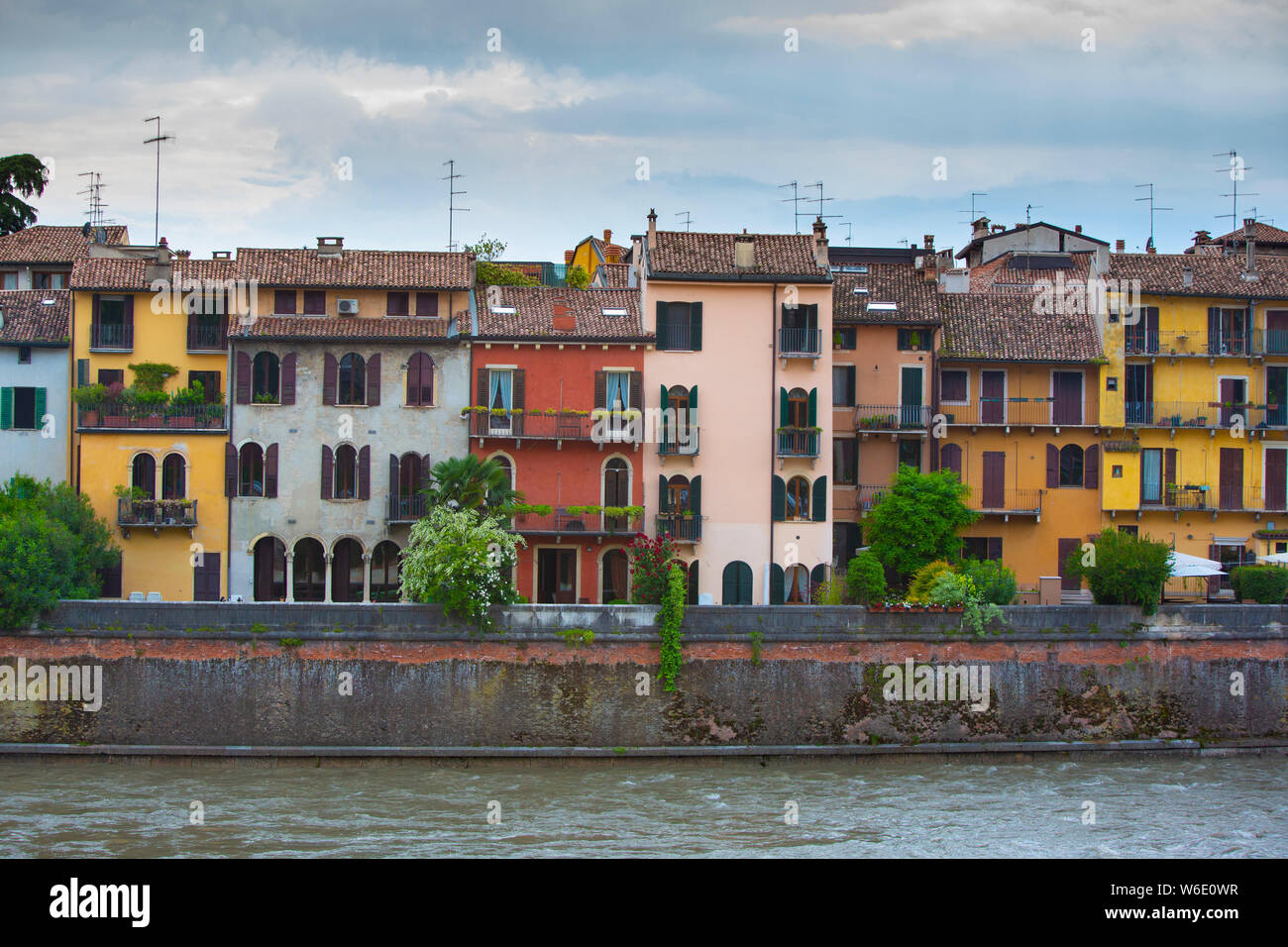 A loop of the River Adige contains the ancient city of Verona, a UNESCO World Heritage Site, in Italy. Via Ponte Pietro houses have backs by the Adige Stock Photo