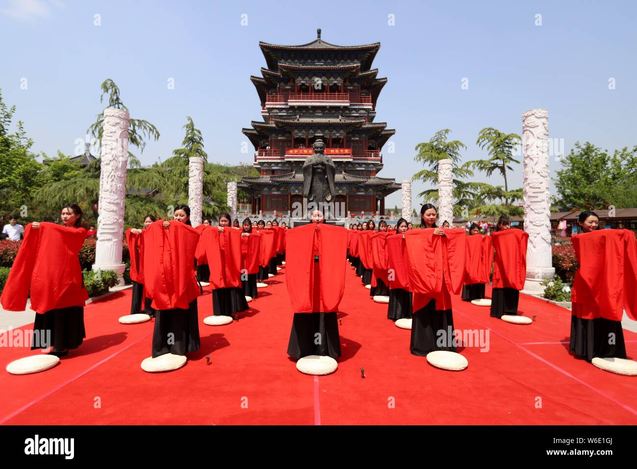 Chinese girls dressed in traditional Han costumes take part in a ...