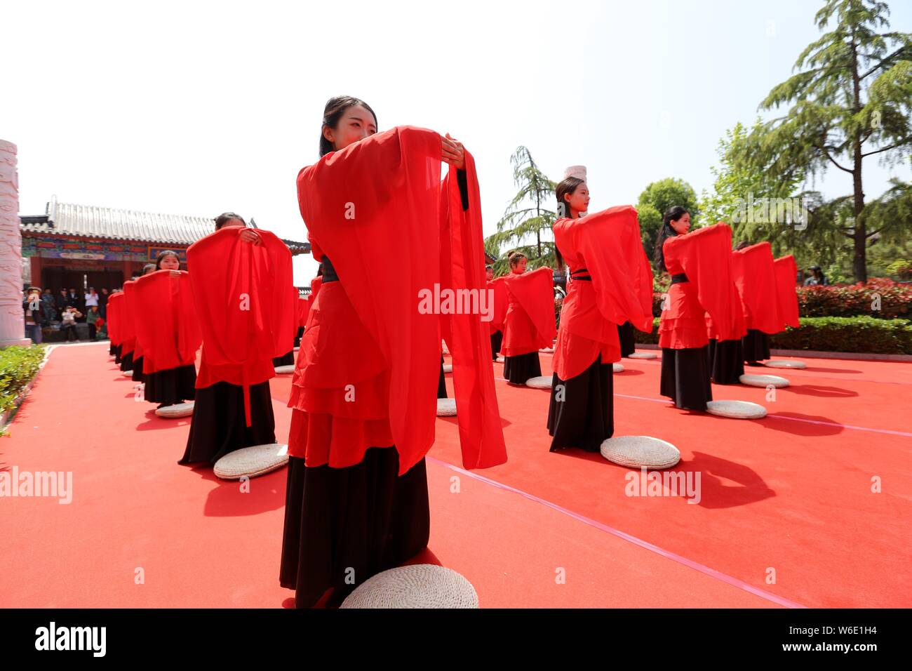 Chinese girls dressed in traditional Han costumes take part in a ...