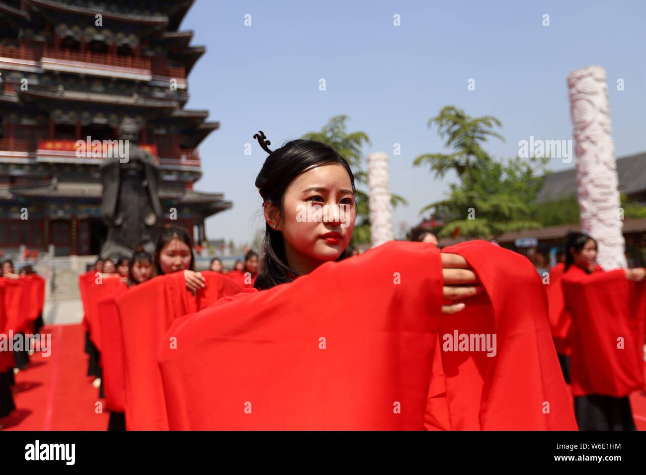 Chinese girls dressed in traditional Han costumes take part in a ...