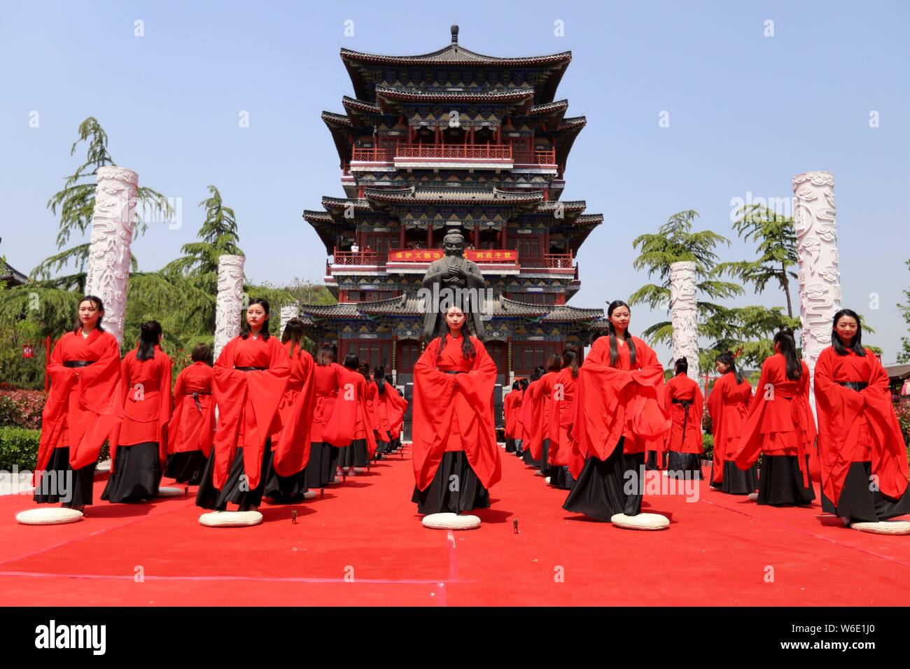 Chinese girls dressed in traditional Han costumes take part in a ...